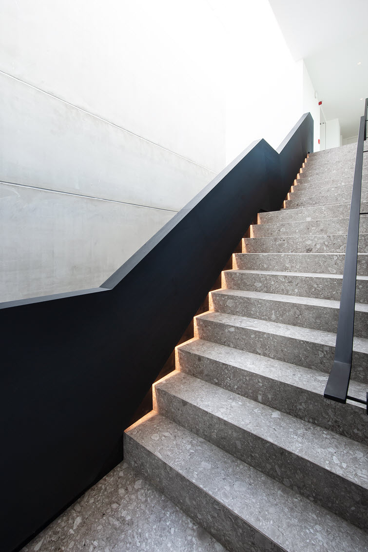 Staircase with a luxurious appearance due to the oak look of Master Oak and indirect lighting.